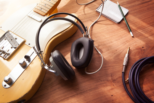 electric guitar setup with headphones and DI box